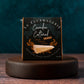 Wedge of 'Camden Cultured Truffle' on a wooden stand with a dark background